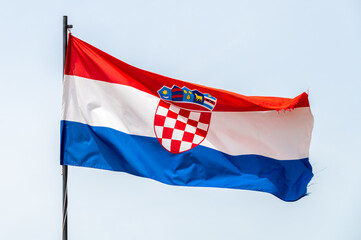 Naklejka na ściany i meble Croatian flag on a pole waving in the wind