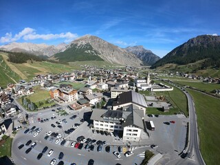Aerial view of a cityscape surrounded by hills