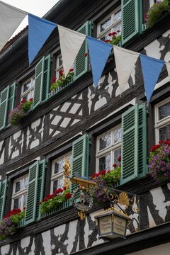 Vertical shot of the exterior of a beautiful building in Bamber with potted flowers and windows