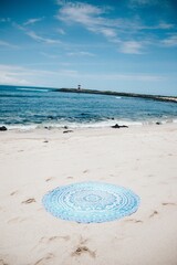 Vertical shot of the mandala mat at the beach