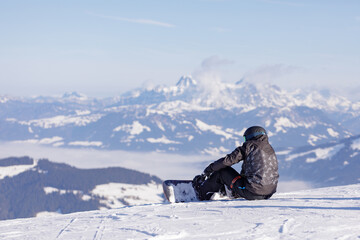 Fototapeta na wymiar man and woman skiing and snowboarding in the mountains, ski resort