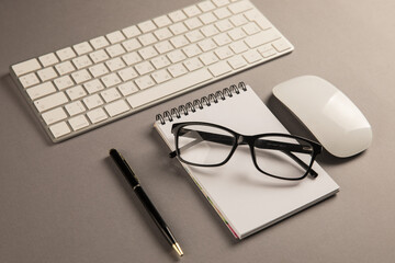 Keyboard, glasses and notepad