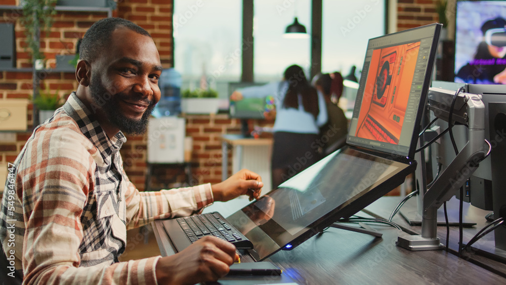 Poster creative office worker sitting at computer and creating digital art in agency studio, using multiple