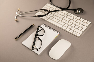 Stethoscope, notepad and keyboard