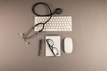 Stethoscope, notepad and keyboard