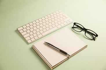 Keyboard, glasses and notepad