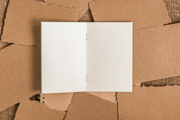 Open album on background of craft paper pieces, vintage background