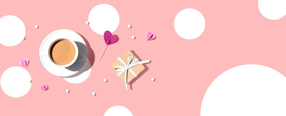 A cup of coffee with a gift box and hearts - flat lay