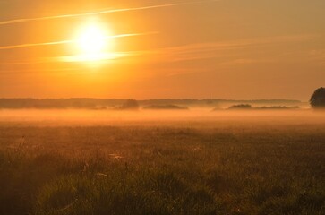 Fototapeta na wymiar Beautiful morning foggy landscape. Sunrise over the river in Ponidzie in Poland.