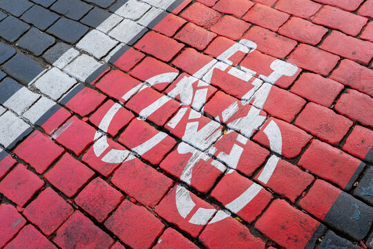 Red bike path sign on the street