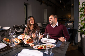 Happy couple Laughing at Dinner Table