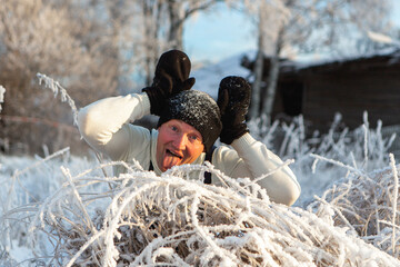 A man shows hare ears in a winter landscape