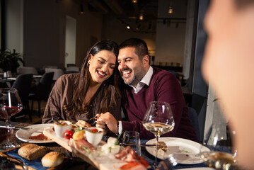 Happy couple Laughing at Dinner Table