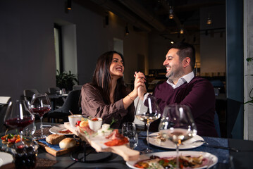 Happy couple Laughing at Dinner Table