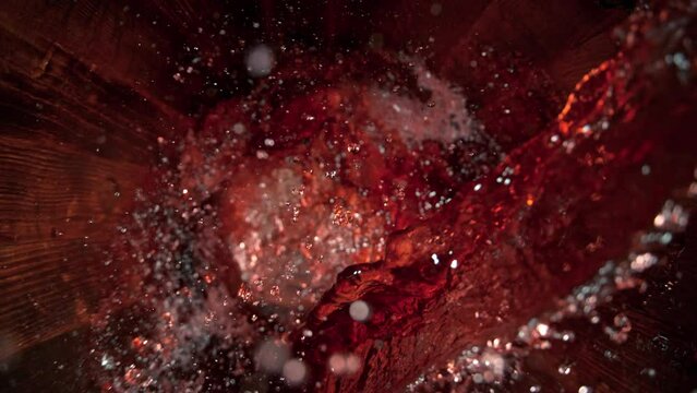 Super Slow Motion Shot of Pouring Red Wine into Old Oak Wooden Barrel at 1000fps.