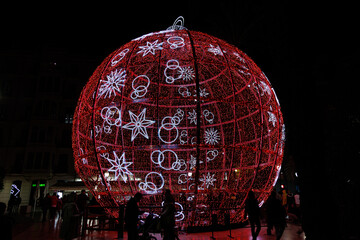 big glowing red bauble Christmas decoration in Alicante, Spain at night