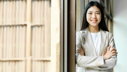 Portrait of confident woman arms crossed smiling at camera.