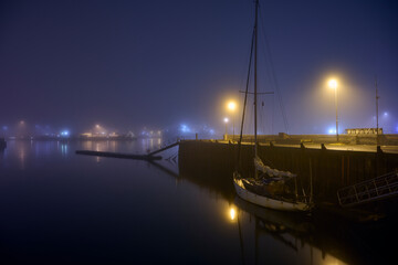 Boat moored in port at night
