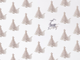 Obraz premium Silver glitter decorative Christmas tree with deer on a white background. Pattern.