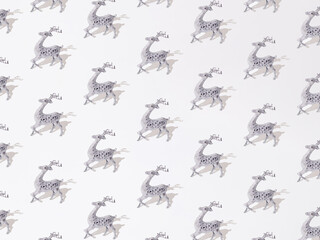 Silver decorative reindeer on a white background. Pattern.