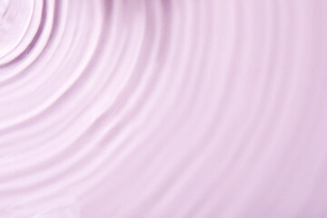 Closeup view of water with rippled surface on violet background