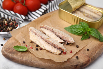 Canned mackerel fillets served on grey table, closeup