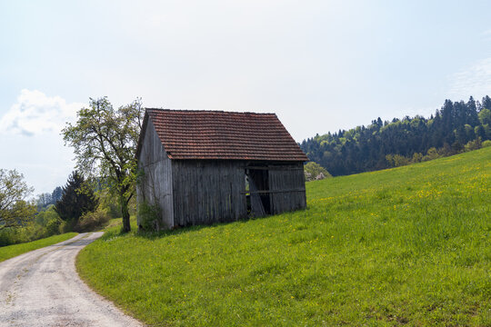 Gravel road to an old wooden Barn in Germany