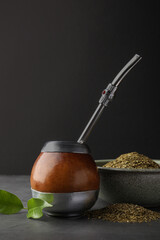 Calabash with mate tea and bombilla on light grey table