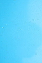 Water drops on light blue background, top view