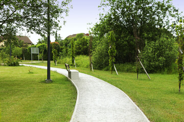 Beautiful green park with path and bench