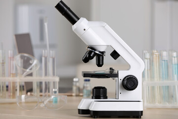 Modern medical microscope on wooden table in laboratory