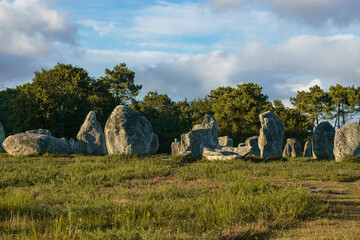 Miles long megalithic stones alignment on green meadow in Carnac, Brittany, France