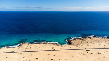 Aerial view of a road in the dunes of the Corralejo Natural Park in the north of Fuerteventura in...