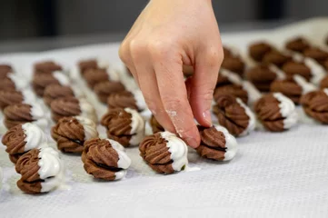 Gordijnen Female making cookies in the kitchen © Nadja Knapp/Wirestock Creators