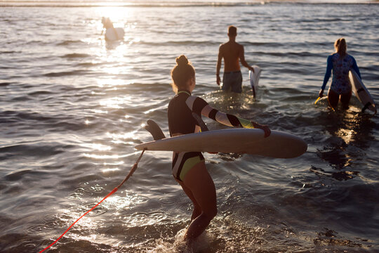 Young woman with surfboard at the beach