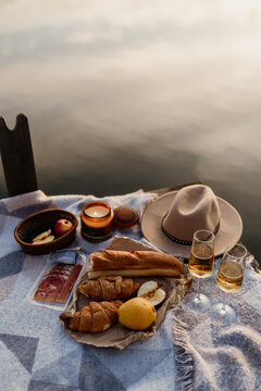 Aesthetic picnic outdoors with wine glasses, bread and berries.