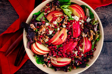 Fall Harvest Apple Pomegranate Salad Viewed From Above: Salad made with lettuce, pecans, feta...