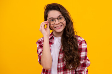 Happy teenager, positive and smiling emotions of teen girl. Portrait of teenager child girl in glasses. Kid at eye sight test. Girl with eyeglasses and looking at camera. Vision for children.