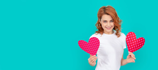 happy young lady with red heart on blue background. Woman isolated face portrait, banner with mock...