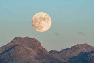 Moon rise over rugged mountains