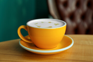 Cup of delicious coffee on wooden table indoors, closeup