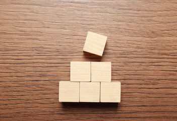 Blank cubes on wooden table, flat lay with space for text. Idea concept