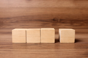 Cubes on wooden background, space for text. Idea concept
