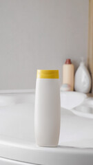 Beige bottle of bubble bath on tub indoors