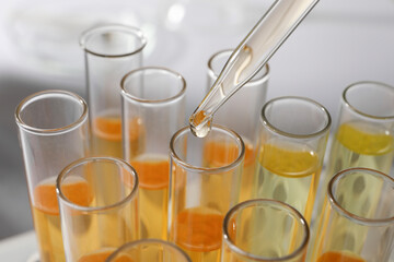 Dropping urine sample for analysis into tube, closeup