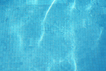 Empty swimming pool with clear water, top view
