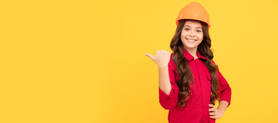 Architect teenager girl. child wear helmet for building. protection and safety. kid education. on construction site. Child builder in helmet horizontal poster design. Banner header, copy space.