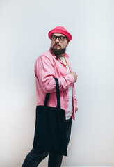 Young man is holding black textile eco bag on white background. Mockup for design