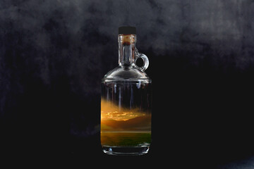 Sunset in a transparent bottle with a black background