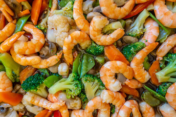 Looking down at Chop Suey with prawns, broccoli and cauliflower, an asian dish at a help yourself...
